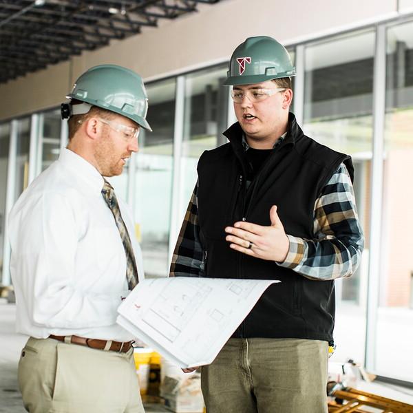 Ty Garner at a Tetrad construction site talking to the job forman.